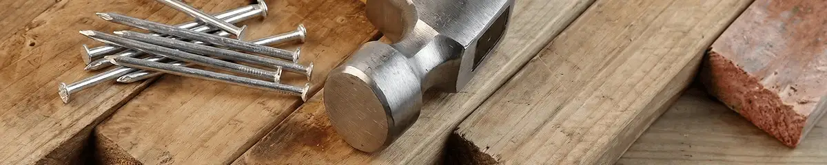 Hammer and nails on hardwood flooring boards in Lakeland, FL