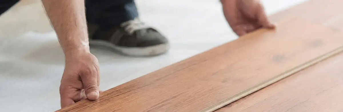 A professional installing laminate flooring in Lakeland, FL